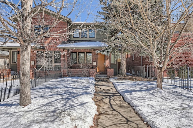 view of front of house with brick siding and fence