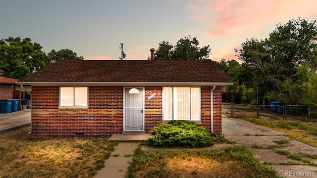 6150 E 65th Ave, Commerce City, CO 80022 - view of front of house featuring brick siding and roof with shingles