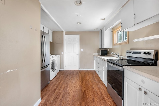 6150 E 65th Ave, Commerce City, CO 80022 - kitchen featuring stainless steel appliances, white cabinetry, light countertops, and light wood-style floors