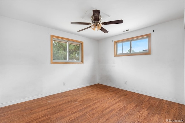 6150 E 65th Ave, Commerce City, CO 80022 - spare room with plenty of natural light, wood finished floors, and ceiling fan