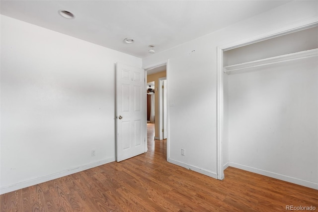 6150 E 65th Ave, Commerce City, CO 80022 - unfurnished bedroom with wood finished floors, a closet, and recessed lighting