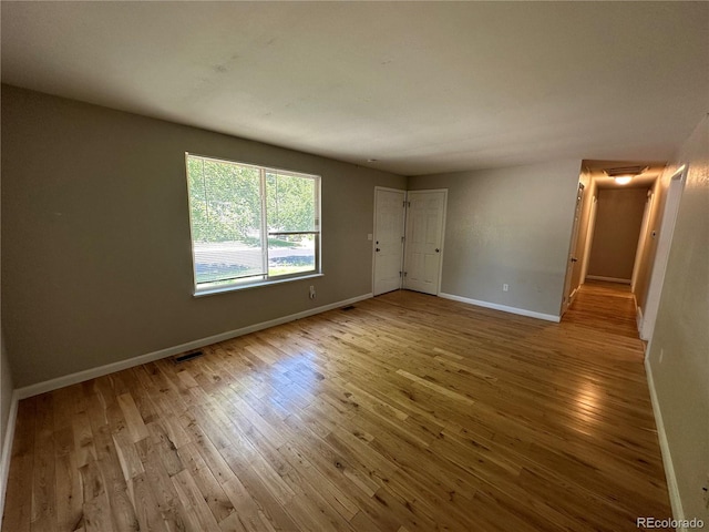 unfurnished room featuring light hardwood / wood-style floors