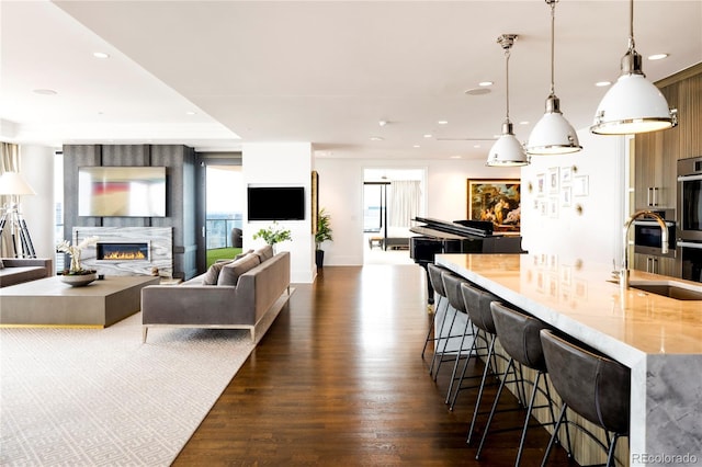1133 14th St Unit 4150, Denver, CO 80202 - living area featuring dark wood-style floors, a premium fireplace, and recessed lighting