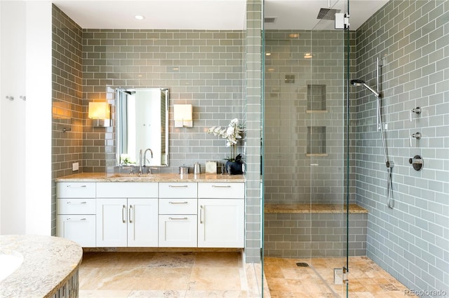 1133 14th St Unit 4150, Denver, CO 80202 - full bathroom featuring vanity, a stall shower, and tile walls
