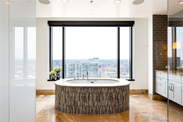 1133 14th St Unit 4150, Denver, CO 80202 - full bathroom with a garden tub, vanity, a city view, and recessed lighting
