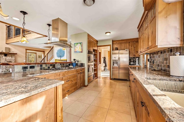 kitchen featuring island exhaust hood, decorative light fixtures, decorative backsplash, light tile patterned floors, and appliances with stainless steel finishes