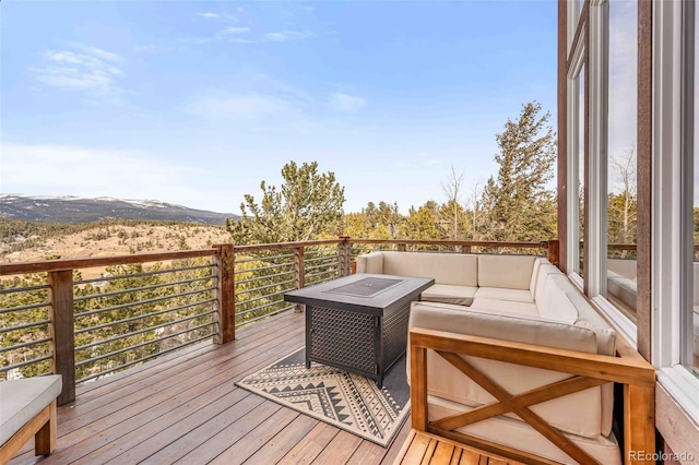 wooden terrace featuring outdoor lounge area and a mountain view