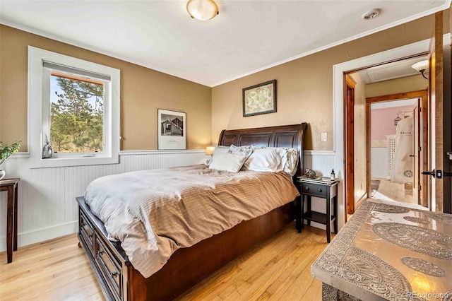 bedroom featuring light hardwood / wood-style flooring and ornamental molding