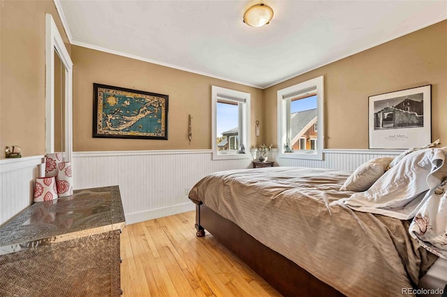 bedroom with light hardwood / wood-style floors and ornamental molding