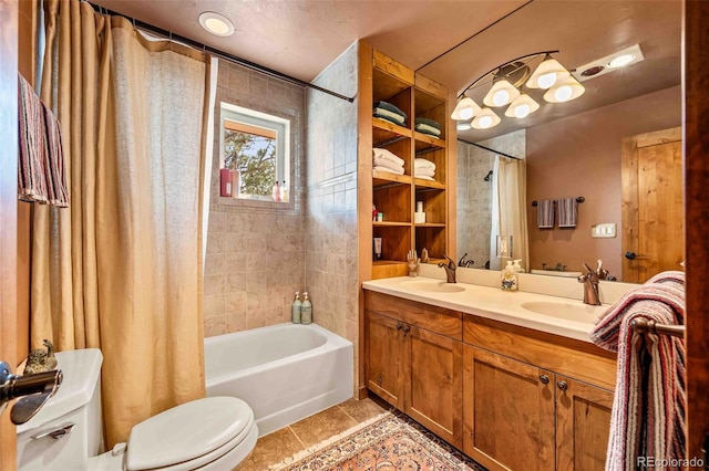 full bathroom with tile patterned flooring, vanity, toilet, and shower / bath combo with shower curtain