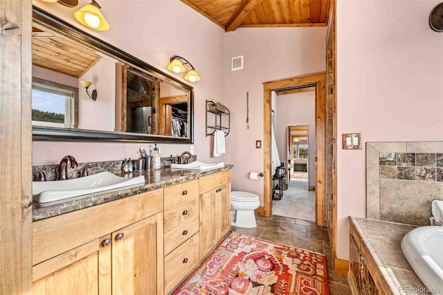 bathroom featuring lofted ceiling with beams, vanity, wood ceiling, and a relaxing tiled tub