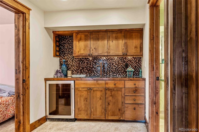 bar featuring decorative backsplash, light carpet, and wine cooler