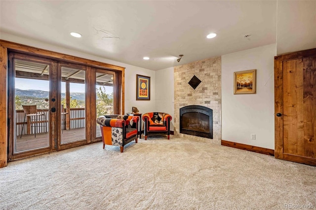 sitting room featuring carpet floors, french doors, and a brick fireplace