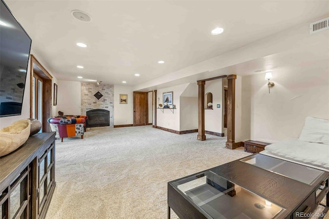 living room featuring light carpet and a fireplace