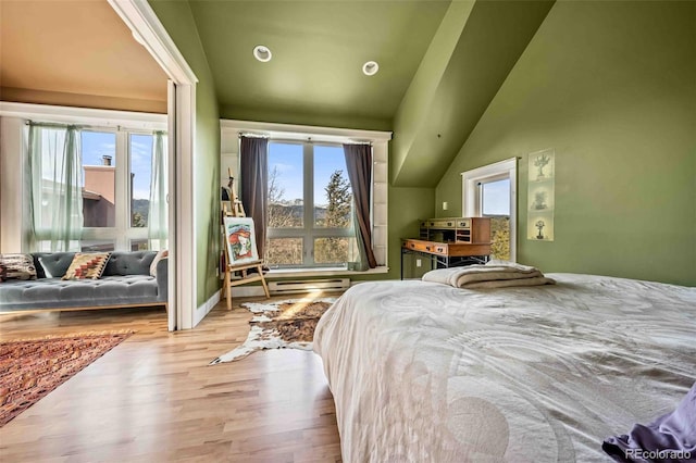 bedroom featuring light hardwood / wood-style floors and vaulted ceiling