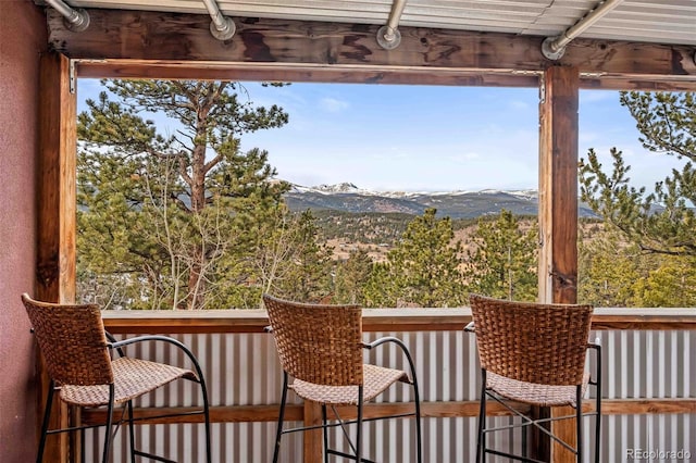 sunroom / solarium featuring a mountain view