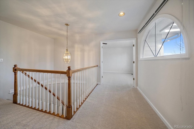 hallway with baseboards, carpet, an upstairs landing, a notable chandelier, and recessed lighting