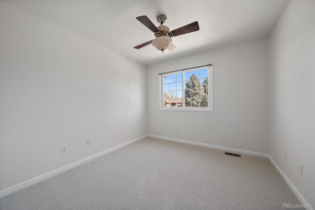 unfurnished room with light carpet, visible vents, a ceiling fan, and baseboards