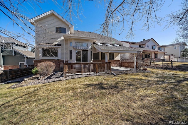 rear view of house featuring a patio, fence, a lawn, and brick siding