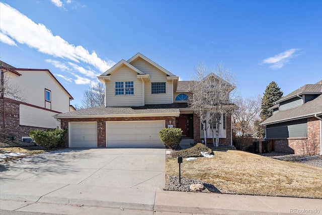 traditional-style house featuring concrete driveway and brick siding