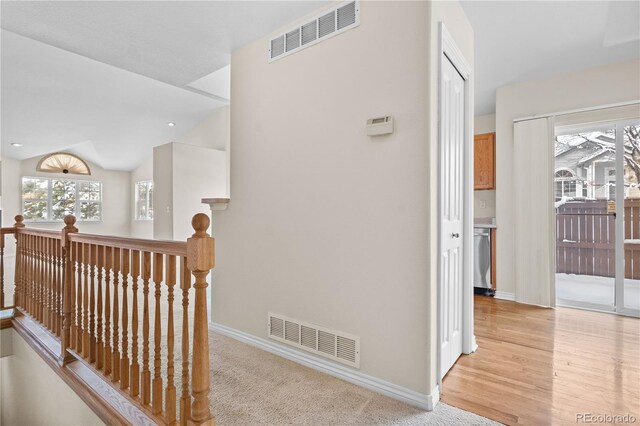 2951 S Walden Ct, Aurora, CO 80013 - hall featuring baseboards, an upstairs landing, light wood-style flooring, and vaulted ceiling