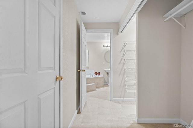 corridor featuring light tile patterned floors