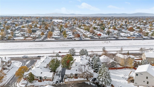 snowy aerial view featuring a mountain view