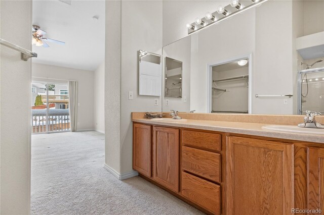 2951 S Walden Ct, Aurora, CO 80013 - full bath featuring a stall shower, double vanity, ceiling fan, a spacious closet, and baseboards