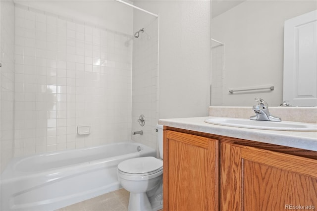 full bathroom with tile patterned floors, vanity, tiled shower / bath combo, and toilet