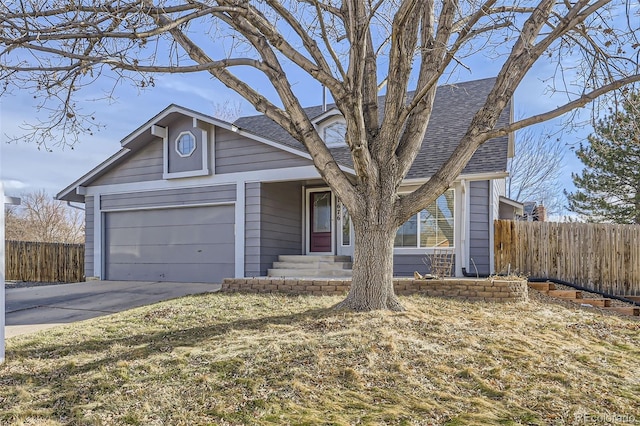 view of front of house with concrete driveway, a shingled roof, a garage, and fence