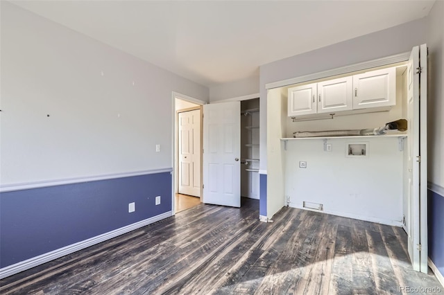 unfurnished bedroom with wood finished floors, a closet, and baseboards