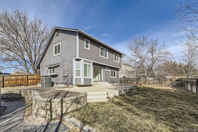 back of house featuring entry steps, a patio, cooling unit, and a fenced backyard