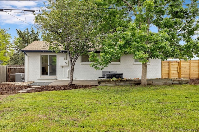 5573 S Huron St, Littleton, CO 80120 - rear view of house with brick siding and a fenced backyard