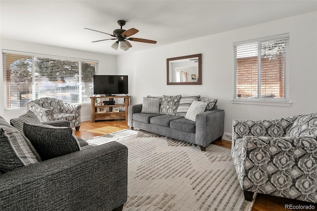 living room with light wood-type flooring and ceiling fan