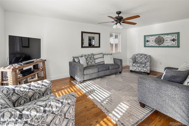 living room featuring ceiling fan and hardwood / wood-style flooring