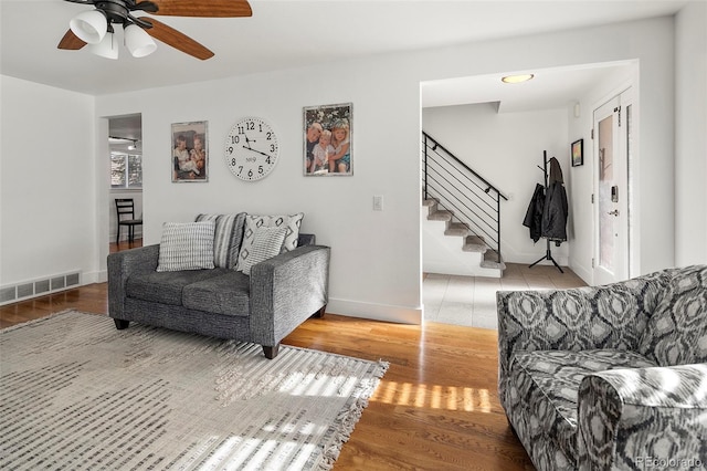 living room with ceiling fan and light hardwood / wood-style flooring