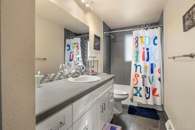 bathroom with tile patterned floors, vanity, curtained shower, and toilet