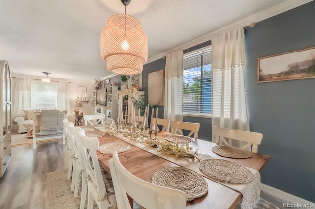 8280 Everett Way, Arvada, CO 80005 - dining room with wood finished floors, ornamental molding, and a chandelier