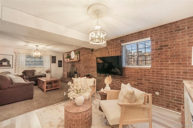 8280 Everett Way, Arvada, CO 80005 - living area with a chandelier, brick wall, a textured ceiling, and a wood stove