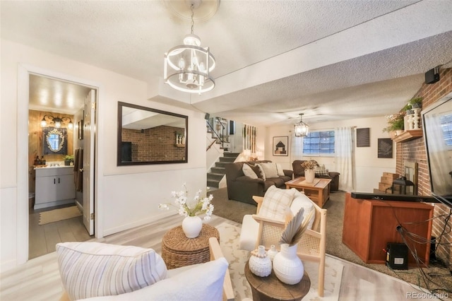 8280 Everett Way, Arvada, CO 80005 - living area with a chandelier, stairs, a textured ceiling, and wood finished floors