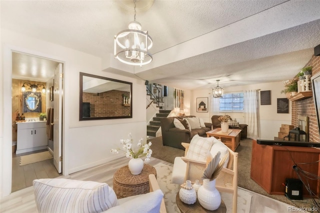 8280 Everett Way, Arvada, CO 80005 - living area with a chandelier, stairs, a textured ceiling, and light wood finished floors