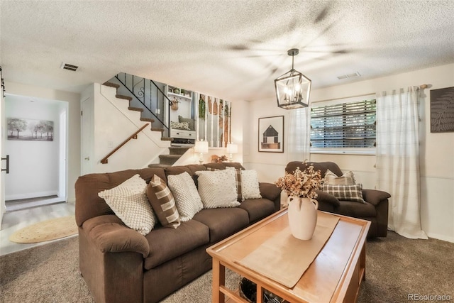 8280 Everett Way, Arvada, CO 80005 - living room with a chandelier, carpet floors, stairs, and a textured ceiling