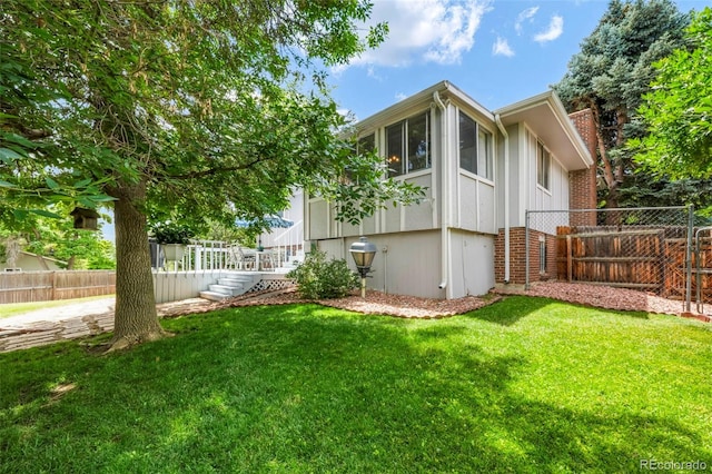 8280 Everett Way, Arvada, CO 80005 - fenced yard featuring a sunroom and stairway