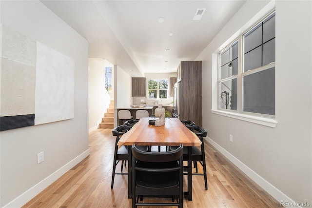 dining space with light hardwood / wood-style floors