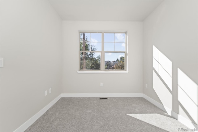 spare room featuring light colored carpet