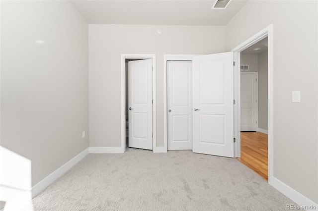 unfurnished bedroom featuring light colored carpet