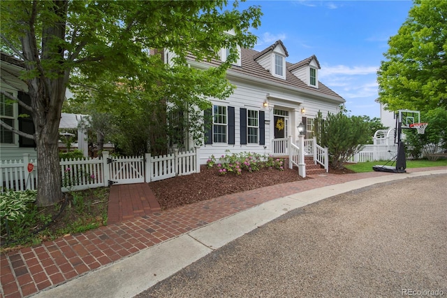 8721 E 23rd Ave, Denver, CO 80238 - cape cod-style house featuring a fenced front yard and a gate