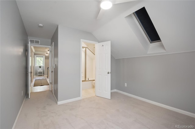 8721 E 23rd Ave, Denver, CO 80238 - unfurnished bedroom with light colored carpet, baseboards, vaulted ceiling, and ensuite bathroom