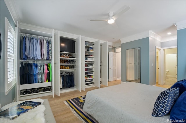 8721 E 23rd Ave, Denver, CO 80238 - bedroom with crown molding, two closets, wood finished floors, and connected bathroom