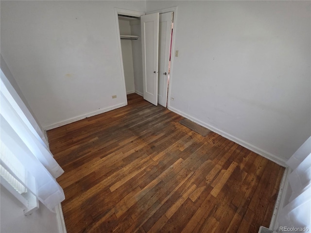 475 Tennyson St, Denver, CO 80204 - unfurnished bedroom with dark wood-style flooring and a closet